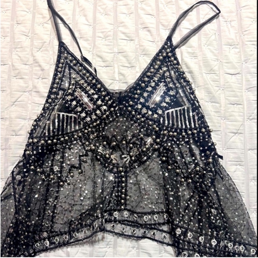 Elegant black sequin beaded top with intricate beaded design.